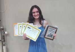 Alumni Sydney Hewer with her awards from both on and off the field.